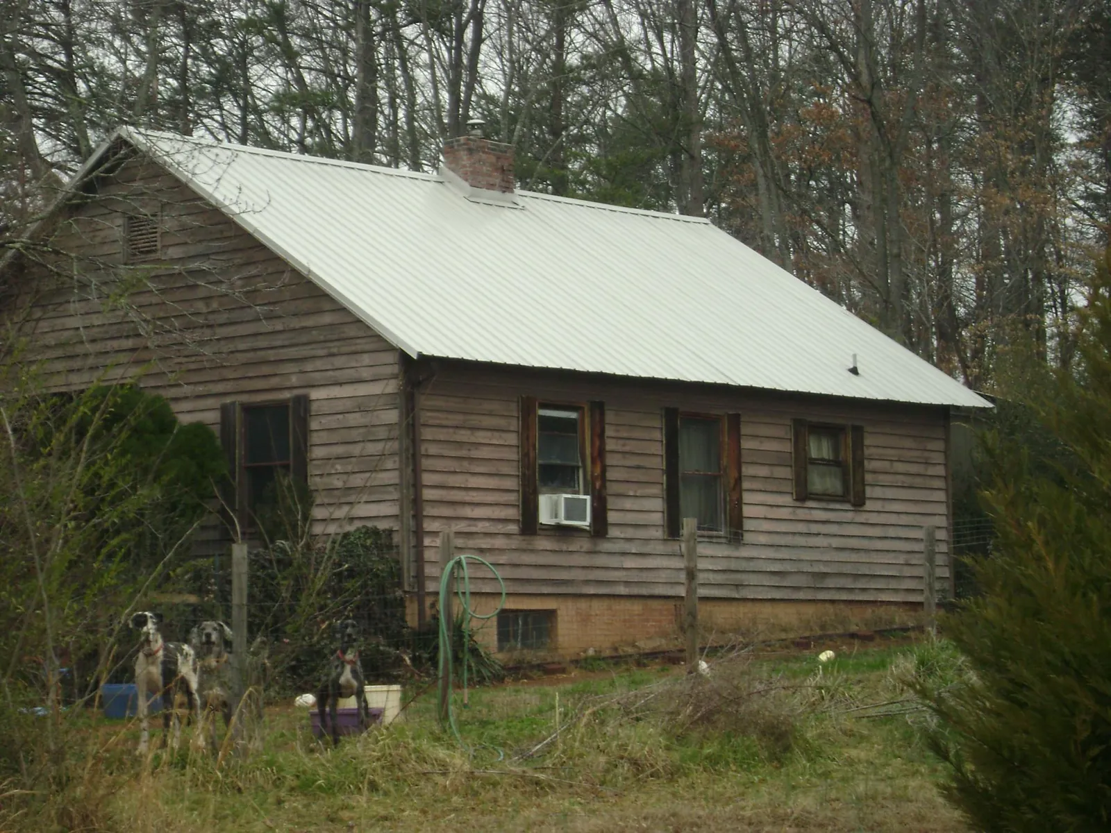 White metal roof on an old wood sided farmhouse, from a Metal Roof Installation job in Freeport